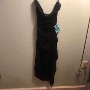 Strapless ruched black dress with blue flower embellishment.